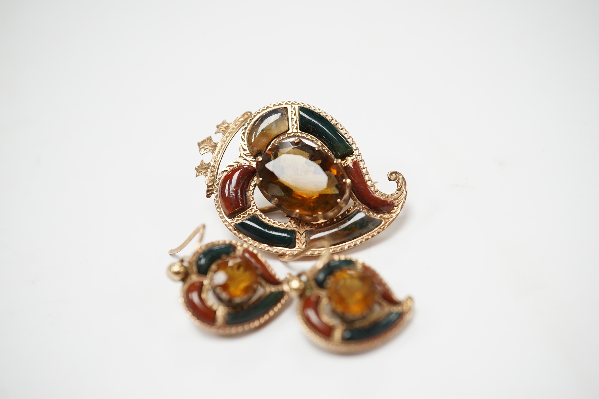 A yellow metal, Scottish hardstone and citrine set suite of jewellery, comprising a brooch, 30mm and pair of earrings, gross weight 7 grams. Condition - fair